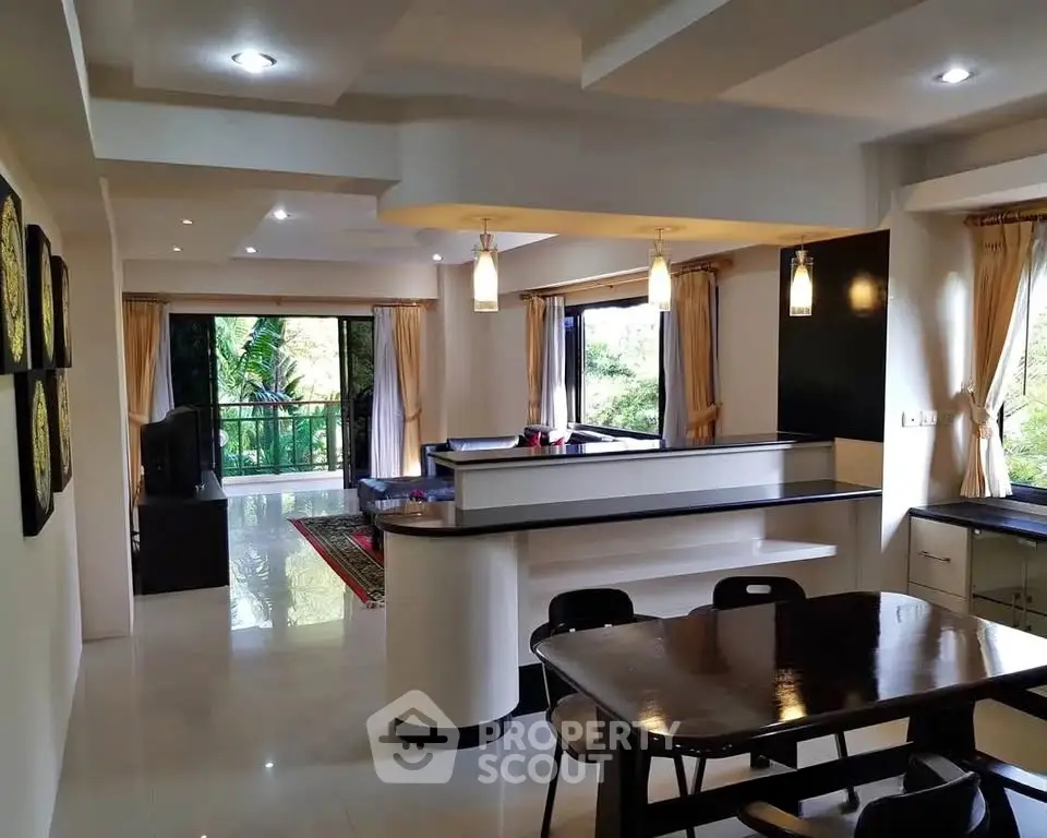 Spacious open-plan living room with modern dining area and lush garden view.