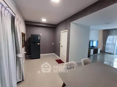 Modern open-plan living and dining area with sleek furniture and stylish decor.