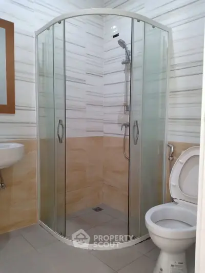 Modern bathroom with glass shower enclosure and sleek fixtures
