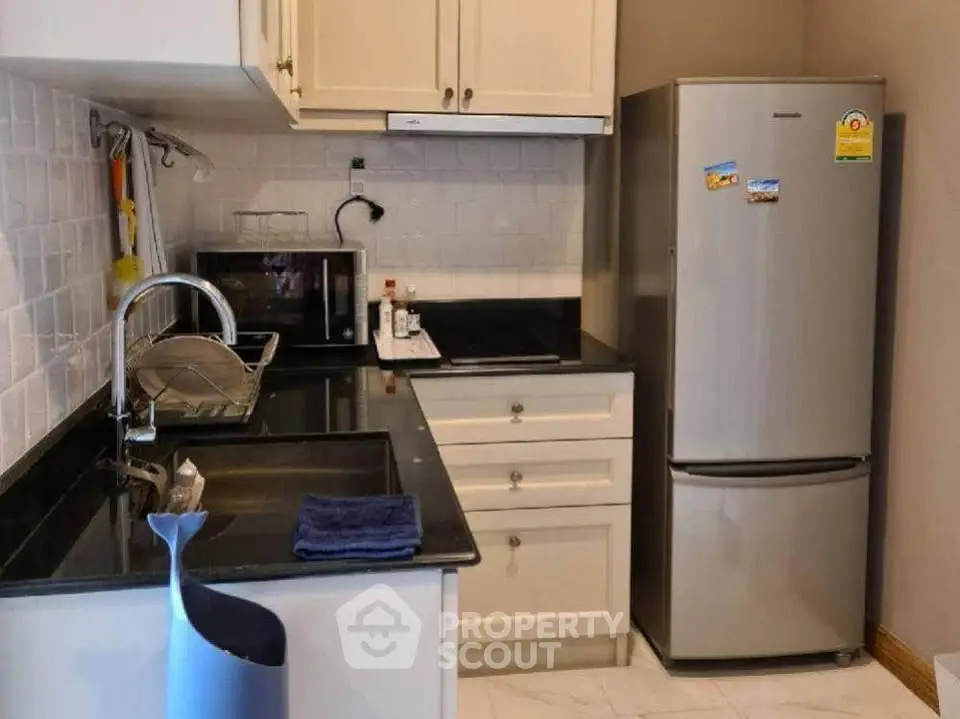 Modern kitchen with sleek appliances and stylish cabinetry, perfect for culinary enthusiasts.