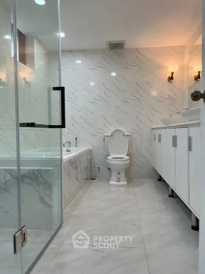 Luxurious modern bathroom with marble tiles and elegant fixtures
