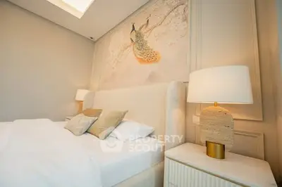 Luxurious bedroom with elegant decor and soft lighting, featuring a stunning peacock mural above the bed.