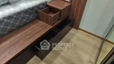 Modern bedroom with stylish wooden storage drawers and sleek flooring