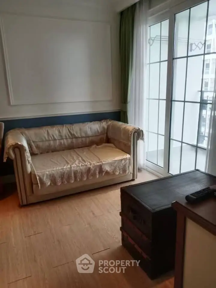 Cozy living room with elegant sofa and large window for natural light