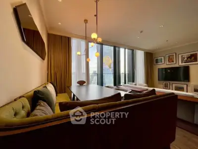 Stylish living room with modern lighting and large windows in a contemporary apartment.