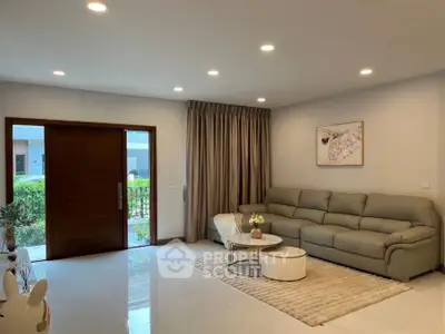 Spacious living room with modern decor and large sofa, perfect for relaxation.