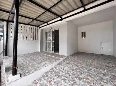 Spacious covered patio with modern tiled flooring and sleek metal roofing, perfect for outdoor relaxation.