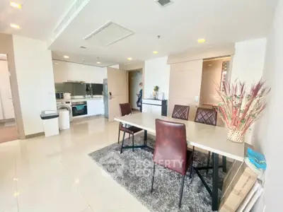 Spacious modern dining area with sleek kitchen in open layout apartment