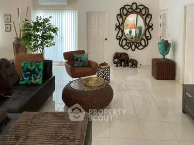 Elegant living room with tropical decor and unique mirror