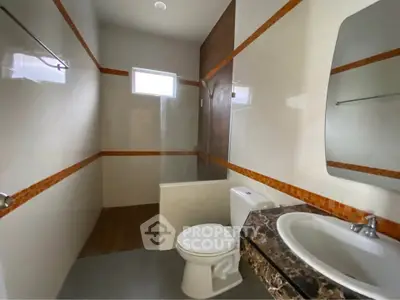 Spacious modern bathroom with elegant marble countertop and sleek design.