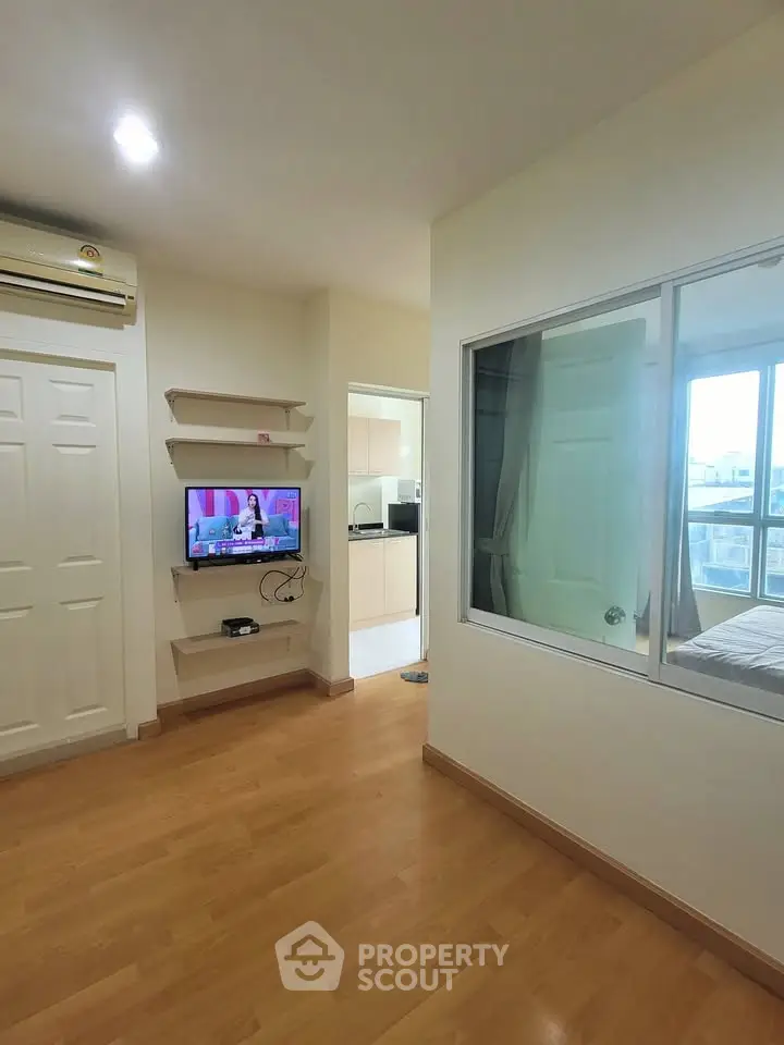 Modern apartment interior with wooden flooring and natural light