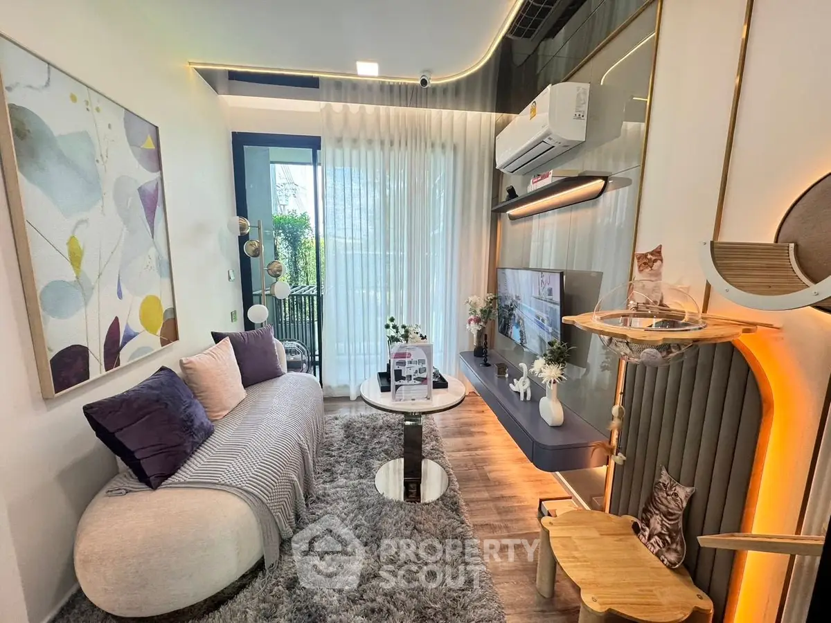 Modern living room with stylish decor, cozy seating, and large window for natural light.