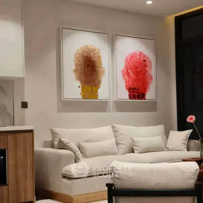 Modern living room with stylish art and cozy white sofa, perfect for relaxation and entertaining.