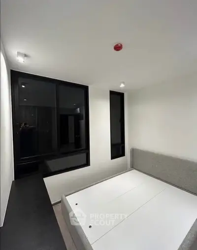 Modern minimalist bedroom with sleek design and large windows