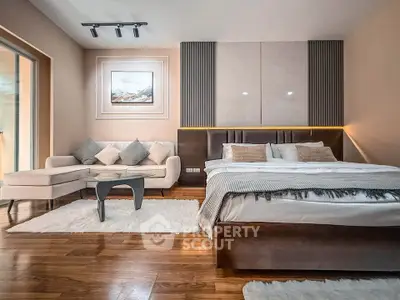 Luxurious modern bedroom with elegant decor and cozy seating area