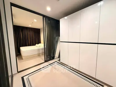 Modern bedroom with sleek white wardrobes and cozy bed in stylish apartment