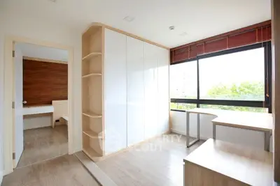 Bright study room with large window and modern furniture