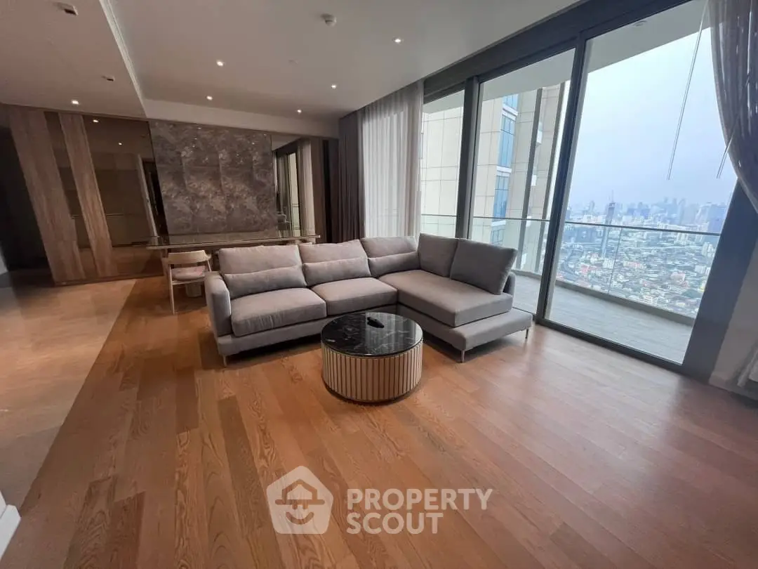 Luxurious living room with panoramic city view and elegant furnishings.