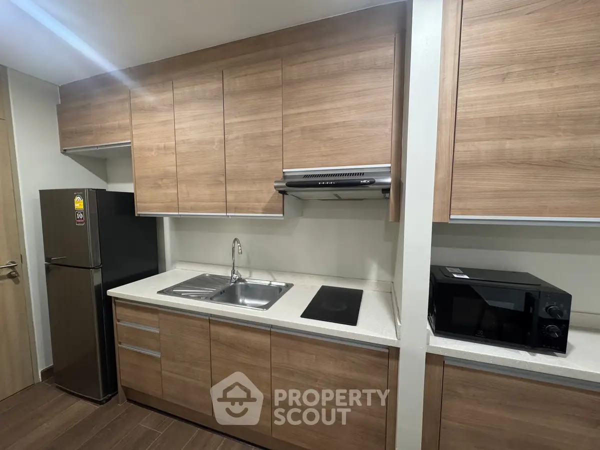 Modern kitchen with sleek wooden cabinets and appliances