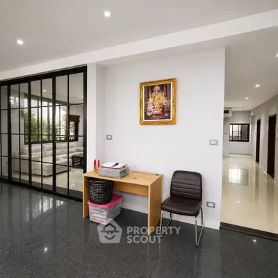 Spacious modern living area with sleek glass partition and elegant decor