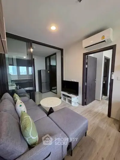 Modern living room with sleek furniture and air conditioning in a stylish apartment.