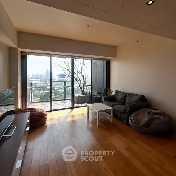Spacious living room with stunning city view and large balcony access.