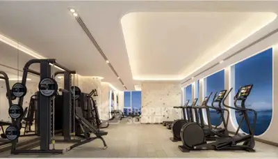 Luxurious gym with modern equipment and stunning ocean view, perfect for fitness enthusiasts.