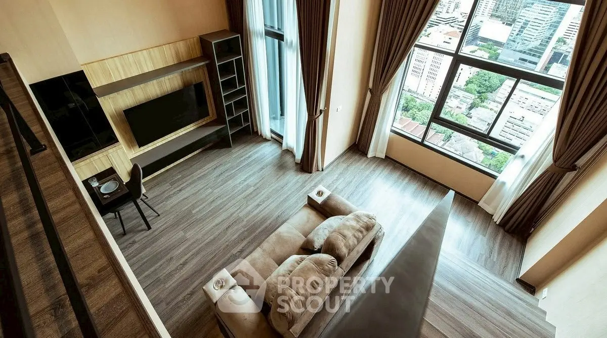 Spacious modern living room with large windows and city view