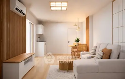 Modern living room with cozy seating and stylish decor in a bright apartment.