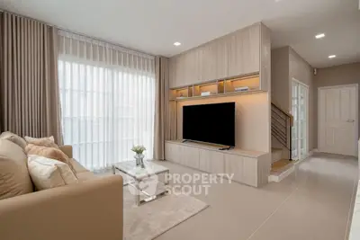 Modern living room with sleek design and large TV unit, perfect for relaxation and entertainment.