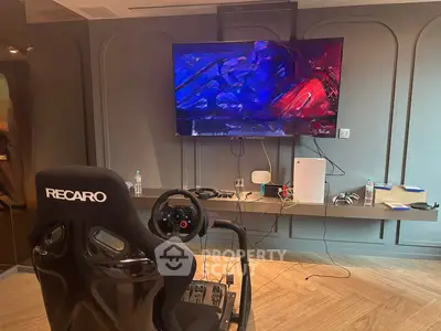 Modern gaming setup with racing chair and large TV in stylish living room