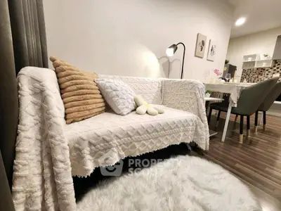 Cozy living room with stylish decor and dining area, perfect for modern living.