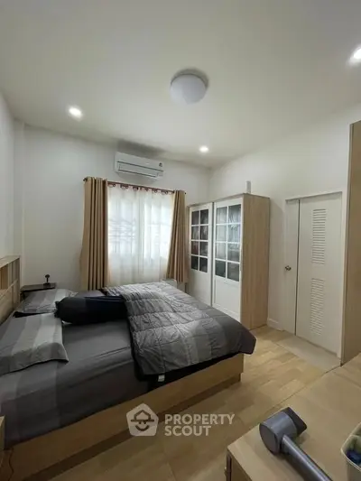 Cozy bedroom with modern furnishings and ample natural light