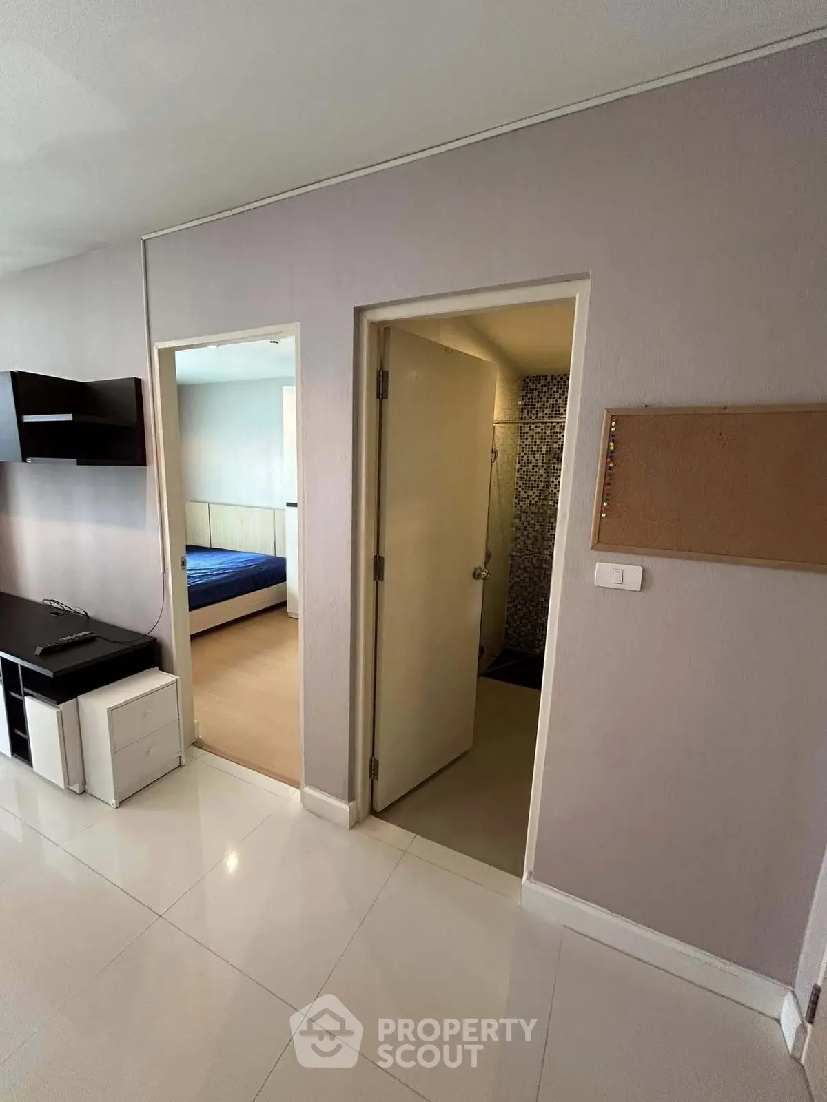 Modern apartment interior with sleek flooring and bedroom view