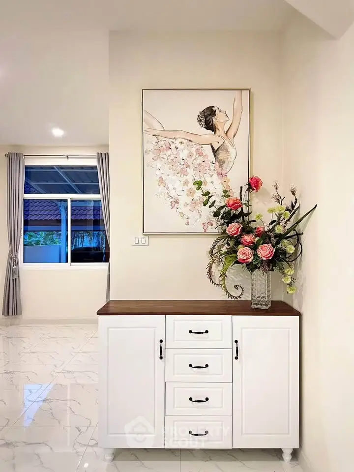 Elegant interior with floral decor and stylish artwork in a bright living space.