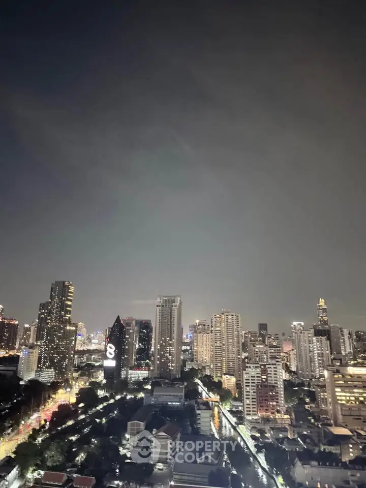 Stunning city skyline view at night showcasing vibrant urban landscape and illuminated skyscrapers.