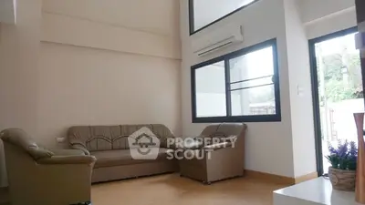 Spacious living room with modern furniture and large windows