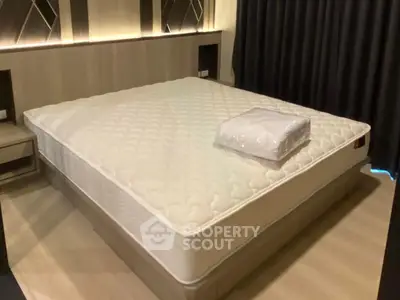 Spacious bedroom with modern design and large comfortable bed, perfect for relaxation.