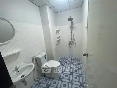 Modern bathroom with shower and tiled floor in real estate property