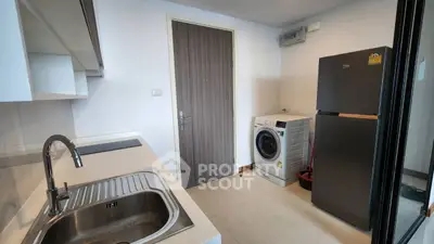 Modern kitchen with washing machine and sleek appliances