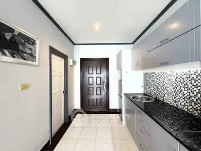 Modern kitchen with sleek cabinets and mosaic backsplash