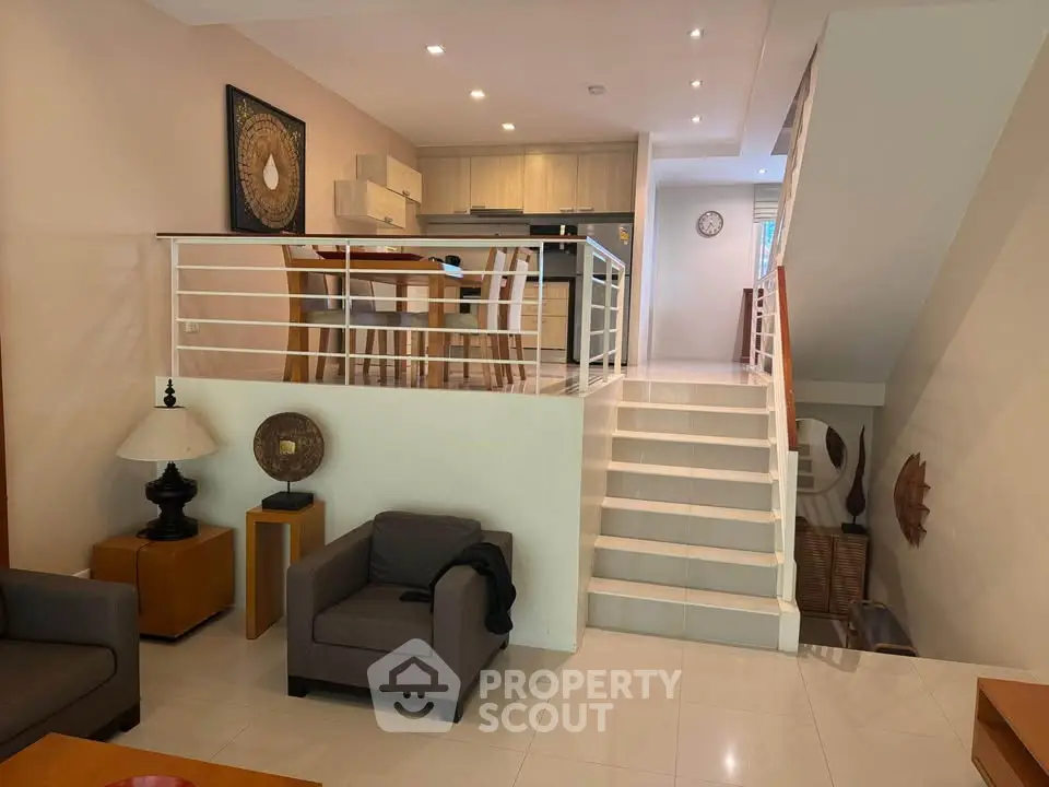 Modern split-level living room with open kitchen and stylish decor