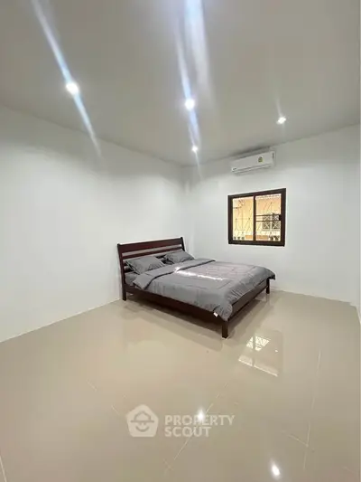 Spacious minimalist bedroom with modern bed and air conditioning