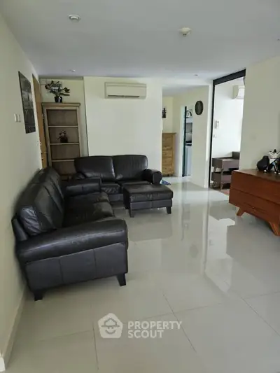 Spacious living room with sleek leather sofas and modern decor