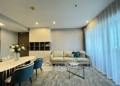 Modern living room with elegant decor and large windows in a stylish apartment.