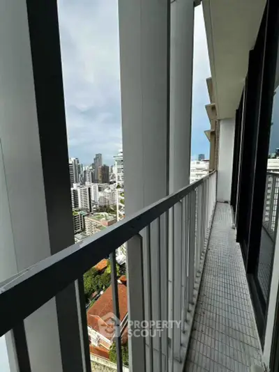 Spacious balcony with stunning city view in modern high-rise apartment