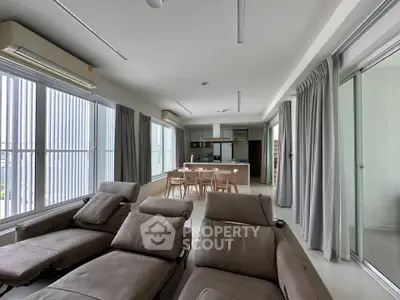 Spacious modern living room with open kitchen and large windows
