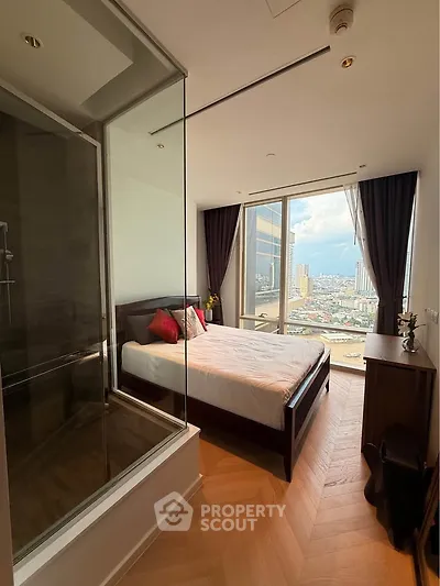 Luxurious bedroom with stunning city view and modern glass-enclosed shower