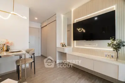 Modern living room with sleek design, wall-mounted TV, and elegant lighting.