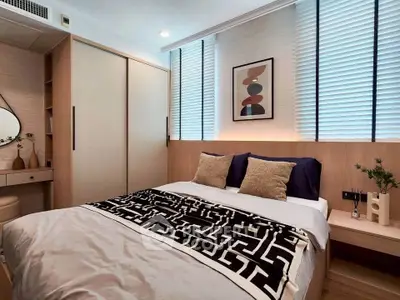 Modern bedroom with stylish decor and ample natural light